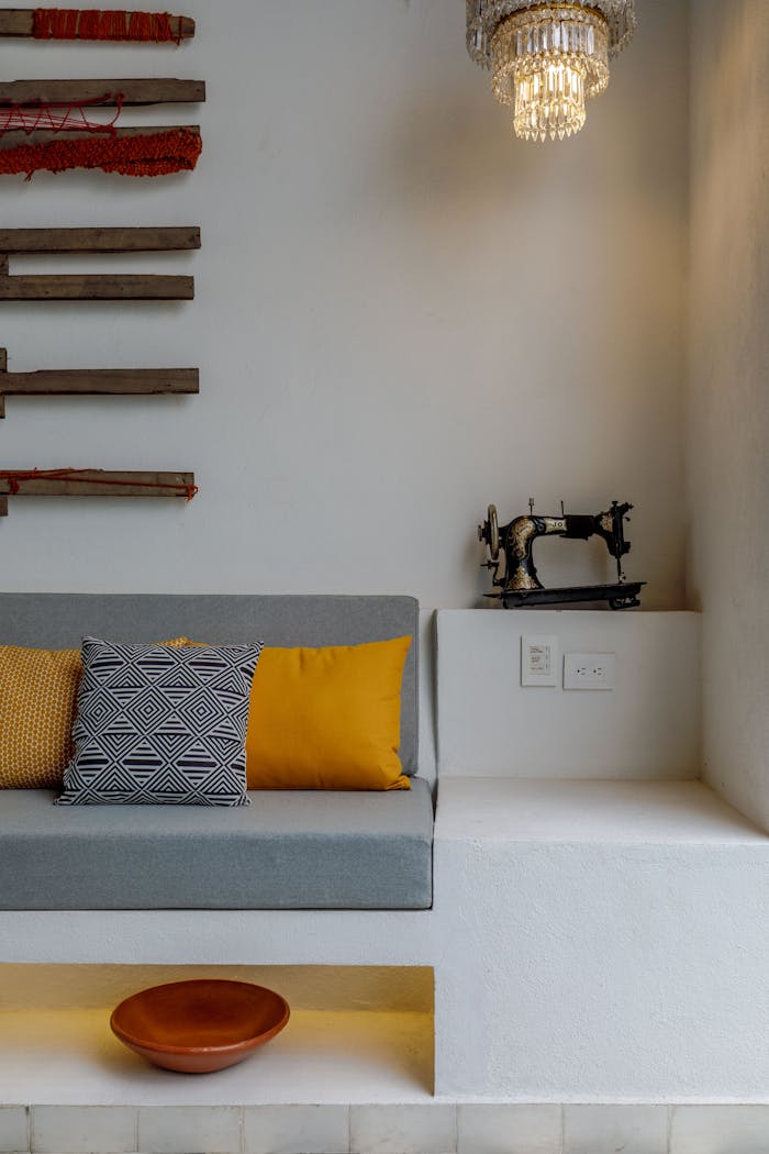 Stylish room interior featuring a vintage sewing machine, cozy cushions, and unique wall decor.